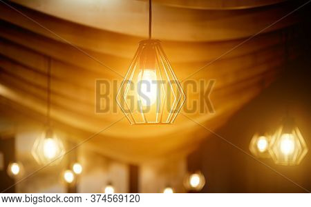 Ceiling Lamps Made Of Rebar Under A Curved Wooden Ceiling