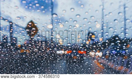 Driving Car On Metropolis Road In Trafic Jam With Raindrop Over The Wind Shield, Rainy Season
