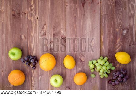 Fruit On The Bottom Edge Of A Mocha Wooden Background