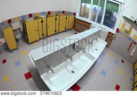 Bathroom Toilet Of The School With Yellow Door  Without People Because There Is The Outdbreak