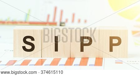 Letters Sipp On Wooden Cubes On Table With Different Color Graphs And Diagram At Bright Light Closeu