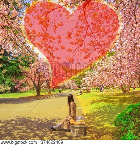 Japanese Woman In Love Under A Blossoming Cherry Tree Of Heart Shape. Shinjuku Gyoen National Garden