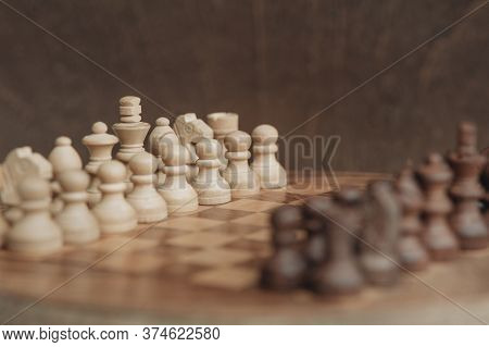 Chess Board And Chess Pieces, Wooden Small Chess Pieces On A Chess Board. Stand In Starting Position