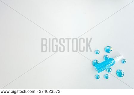 Blue Gel Spray, Drops, Glass, On A White Background, Top View. Copy Space
