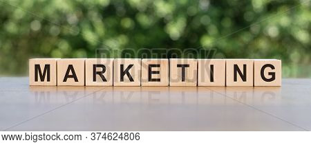 Wooden Blocks With The Text: Marketing. The Text Is Written In Black Letters And Is Reflected In The