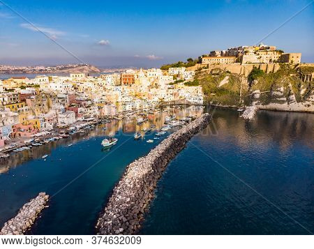 Aerial Drone View Of Vibrantly Colorful Houses Of Marina Corricella In Sunny Summer Weather At Proci
