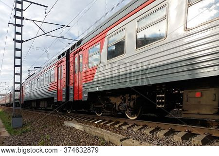 Moscow 02/06/2019 Gray And Red Electric Train Passing By, Side View, Closeup, Perspective Lines, Rai