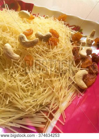 Golden Colored Semiya Vermicelli And Nuts Taken In A Plate After Partial Cooking The Mix.can See The