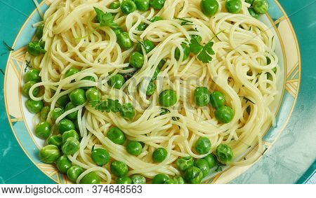 Spaghetti Con I Piselli E Mentuccia - Napoletana Dish Made With Peas, Herbs And Onions