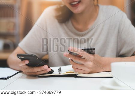 Close Up Hand Of Person Shopping In Mobile And Paying Via Internet Bank.