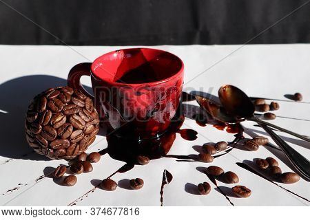 Coffebeans Ball Decoration  and a Red Cup with instant Coffee on a Table