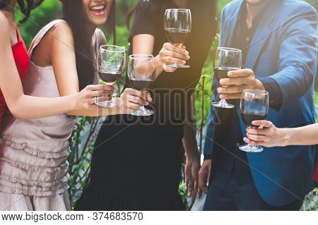 Happy Friends Enjoying  Xmas / New Year Party. Group Of Friends Cheering With Wines In The Fancy New