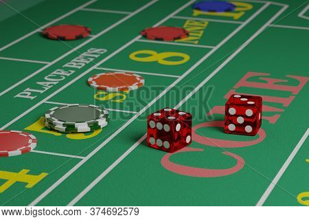 Two Dice On A Craps Table Next To Some Chips.
