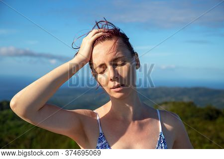 Woman With Sunstroke On Tropical Island. Healthcare On Summer Vacation Photo. Woman With Sun Stroke 