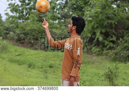 A Boy Playing Football On The Road. 28 June 2020 Mandla Raod Madhya Pradesh,india.