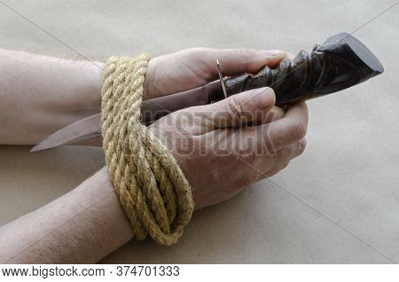 Man, Using A Knife, Cuts His Bound Hands On His Own. Release From Captivity, Freedom Concept. Adult 