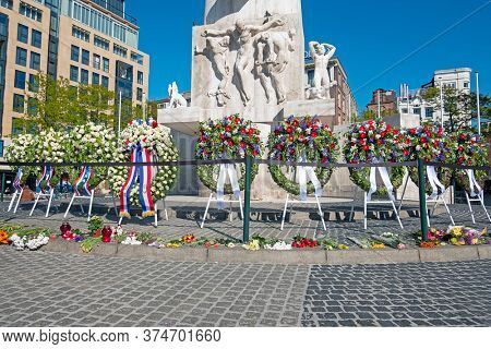 Amsterdam, Netherlands - May 5, 2020: Wreaths at the National Monument on the occasion of remembrance of the worldwar II in Amsterdam the Netherlands