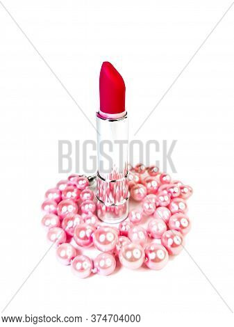 Bright Pink Open Lipstick In A Silver Case And Pink Pearl Beads Isolated On A White Background. Make