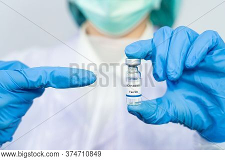 Coronavirus Vaccine Covid-19 Bottle For Injection In Hand Of Doctor Or Technician Scientist In A Pro