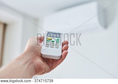Remote Control For Air Conditioner In Hand. Room Condition Remote Control. Air Temperature Switch Fo
