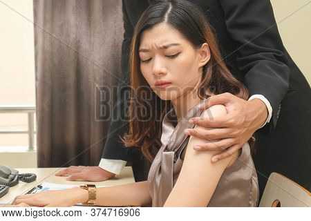 Sexsual Harassment In Workplace. Unhappy Female Employee Looking At Hand Of Boss Touch At Her Should