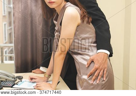 Sexsual Harassment In Workplace. Unhappy Female Employee Looking At Hand Of Boss Touch At Her Hip An