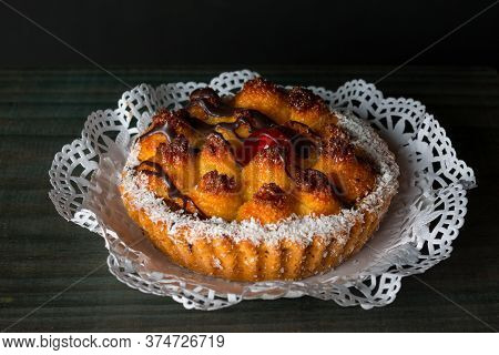 Coconut Cake On A Dark Wooden Background.