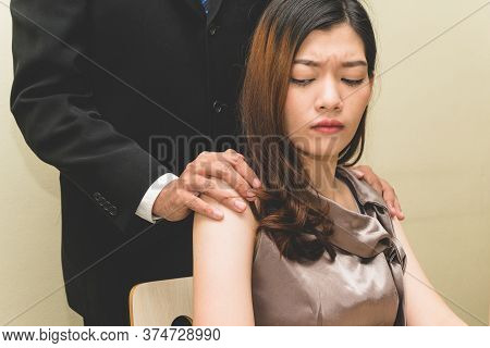 Sexsual Harassment In Workplace. Unhappy Female Employee Looking At Hand Of Boss Touch At Her Should