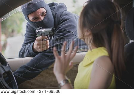 Man Attacking Young Lady By Gun In The Car. Woman Trying To Defend Herself.