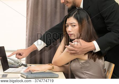 Sexsual Harassment In Workplace. Unhappy Female Employee Looking At Hand Of Boss Touch At Her Should