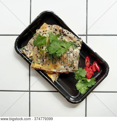 Top View Of Fried Chinese Pancake Or Fried Steamed Dumpling Made Of Garlic Chives, Rice Flour And Ta