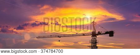 crane at sunset with orange clouds, in the capital of Botswana, Gaborone