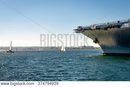 View Of The San Diego Bay With Sailing Boats And The Prow Of The Uus Midway.