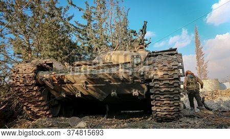 Fighters Standing Above A Destroyed Tank In Syria