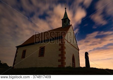 Mystic Chapel Under Cloudy Spangled Sky At Night