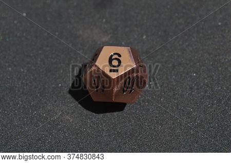 Copper Metallic D12 Twelve Sided Dice On Foam Surface