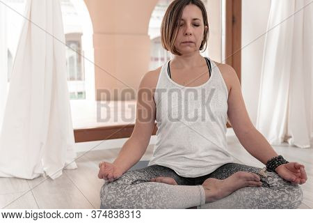 Yoga Teacher Sitting In The Lotus Position. Woman Practicing Yoga. How To Keep Your Arms  For A Kriy