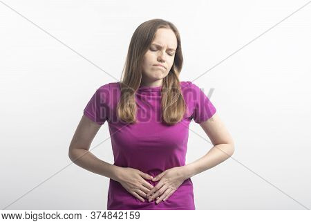 Caucasian Young Woman In Violet T-shirt With Stomachache Putting Her Hands On Ab Squirming In Pain O