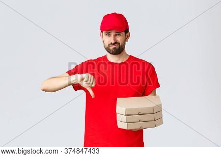 Food Delivery, Quarantine, Stay Home And Order Online Concept. Disappointed And Reluctant Courier In