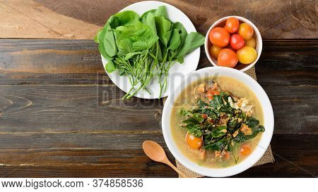 Northern Thai Food (kang Pak Seaw), Spicy Soup With Bauhinia Purpurea Leaf And Spoon On Wooden Backg