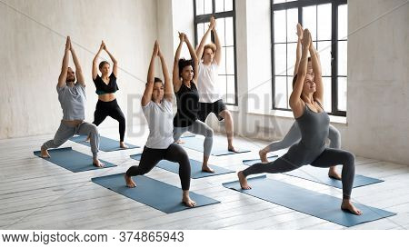 Motivated Happy Multiracial People Doing Surya Namaskar.