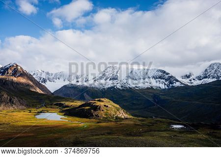 Awesome Picturesque View To Mountain Range In Sunny Day. Beautiful Green Highland Relief With Glacie