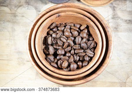 Coffee Beans In A Bowl On A Wooden Table