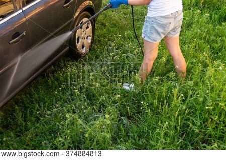 Car Wash, A Woman In Blue Gloves Washes A Car With A Karcher