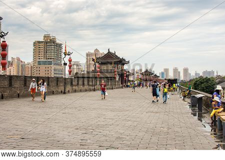 Xian, Shaanxi Province / China - August 4, 2015: People Walk On Top Of The Xian City Walls, Largest 