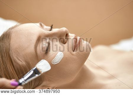 People, Beauty, Cosmetology And Treatment Concept - Close Up Of Beautiful Young Woman Lying With Clo