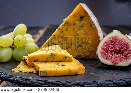 British Matured Yellow Cheese Blue Shropshire, Close Up On Black Stone