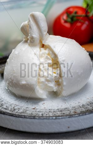 Eating Of Fresh Handmade Soft Italian Cheese From Puglia, White Balls Of Burrata Or Burratina Cheese