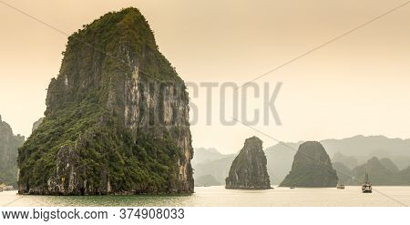 Limestone Karst Islands On A Misty Day In The The Unesco World Heritage Site Of Ha Long Bay, In Viet