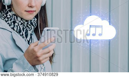 The Concept Of Listening To Music From The Cloud On A Smartphone. The Girl Is Holding The Phone